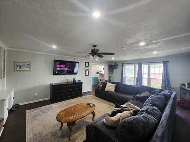 Living room with dark wood-type flooring and a tex