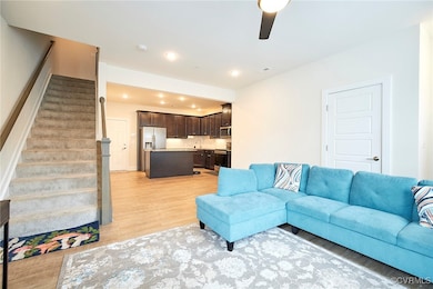 Living area featuring stairway, recessed lighting,