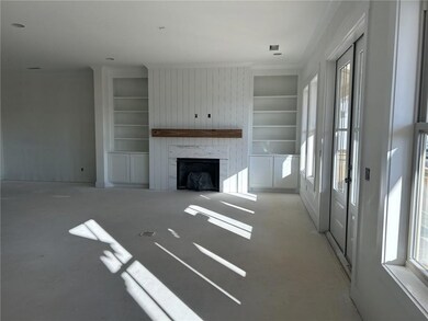 Unfurnished living room with built in features and