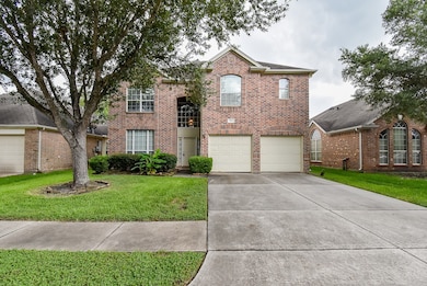 This is a two-story brick home with a double garag