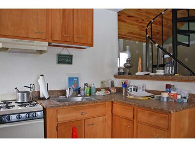 Kitchen wood cabinets and tile floors in the kitch