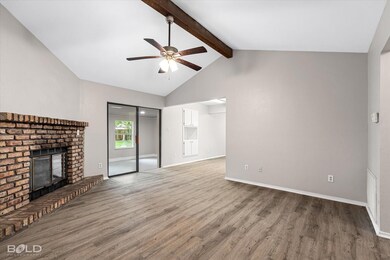 Unfurnished living room featuring beamed ceiling, 