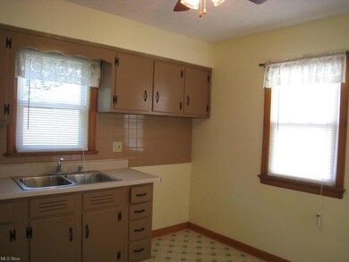 The kitchen is fresh, bright, and has space for ta