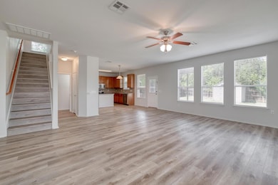 Unfurnished living room with ceiling fan, light w