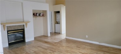Unfurnished living room featuring estacked washer
