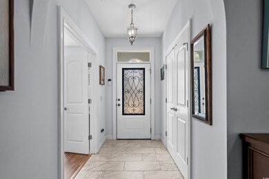 Doorway to outside featuring marble finish floor a
