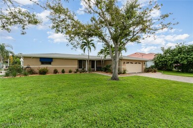 Single story home featuring a front yard and a gar