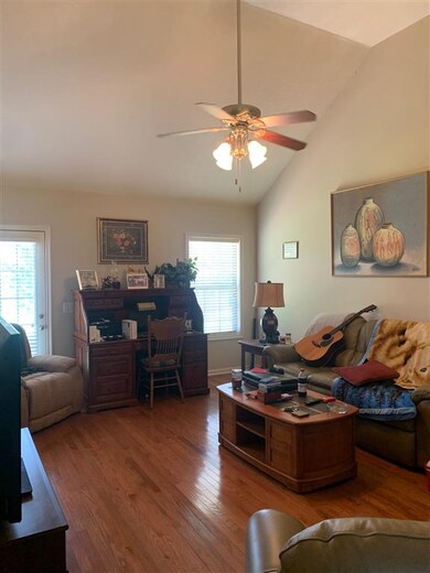 Living room with high ceilings, hardwoods and ceil