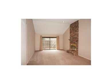 Family room w/brick fireplace; walk-out to private