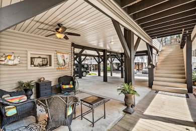 View of patio with stairs, a ceiling fan, and a deck
