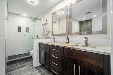 Spa-Like Ensuite Bath with Dual Vanities, a Large Soaking Tub, and a Separate Glass Shower.