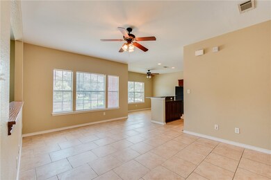 Spare room with ceiling fan, light tile patterned