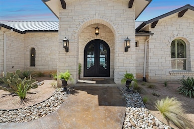 Doorway to property with stone siding, a standing