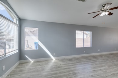 Empty room with light wood finished floors, basebo