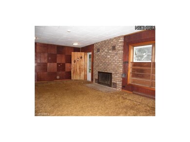 Large living room with wood burning fireplace.