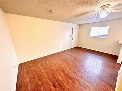 Spare room with wood finished floors, baseboards,