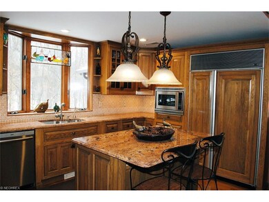 Kitchen with center island and granite counters.