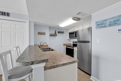 Kitchen with visible vents, a peninsula, appliance