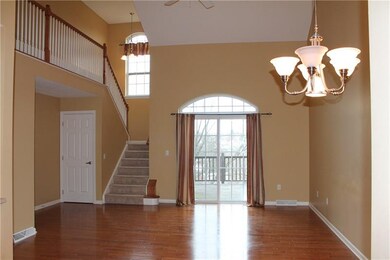The dramatic 2-story great room with hardwood floo