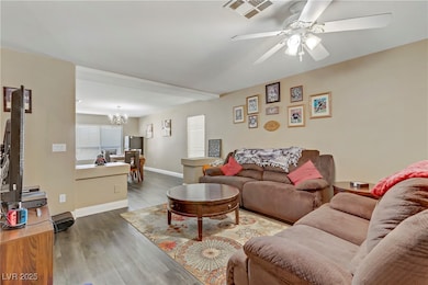 Living area with dark wood-style flooring, visible