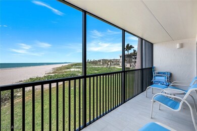 Sunroom / solarium featuring view of water and bea