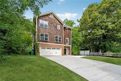 View of front of home featuring a garage and a front lawn