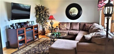 This warm livingroom has oak hardwood flooring.