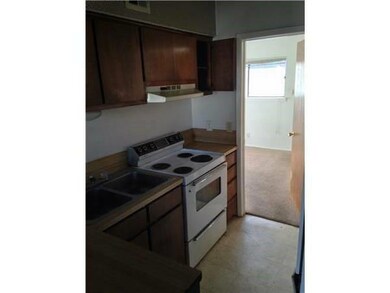 Kitchen featuring electric range, a sink, light c
