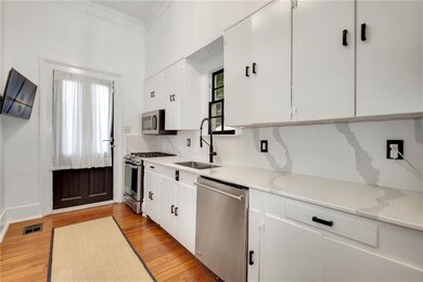 Kitchen complete with mounted TV and gas range