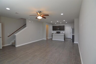 Unfurnished living room featuring a ceiling fan, 
