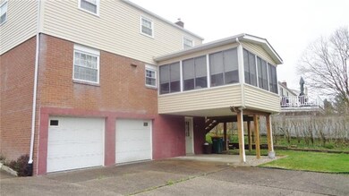 REAR OF HOME, SHOWING SUN ROOM, WITH STEPS TO BACK