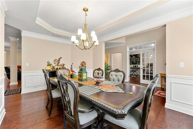 Dining room with dark wood-type flooring, a notabl