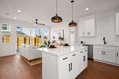 Kitchen with a sink, visible vents, dark wood-sty