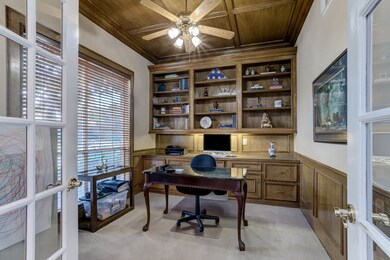 Study has French Doors, built in drawers and shelves and wood paneled ceiling.