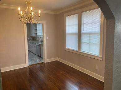 Unfurnished dining area featuring dark hardwood / 