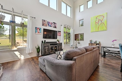 Living room featuring dark wood-style flooring, b
