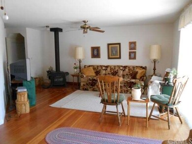 Woodstove in corner of living room. 