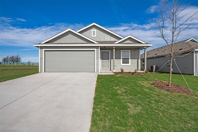 View of front of home with a garage and a front la