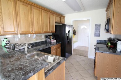 HERE IS ANOTHER VIEW OF THE KITCHEN WHICH OFFERS A BREAKFAST BAR!