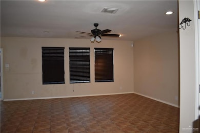 Empty room featuring a ceiling fan and recessed lighting