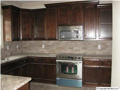 Kitchen with stainless steel appliances, Granite counters, and custom wood cabinets.