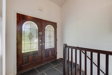 Tiled entrance foyer featuring french doors