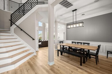 Dining area featuring stairway, visible vents, an