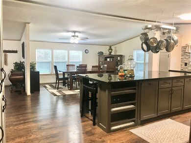 Upon entering the dining & kitchen spaces, you will see the huge 9'x5' ft seating island with classic black fleck granite & tons of storage all around. Note the book shelf for your chef's favorite cookbooks.