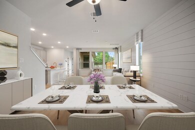 Dining space featuring wood walls, visible vents,