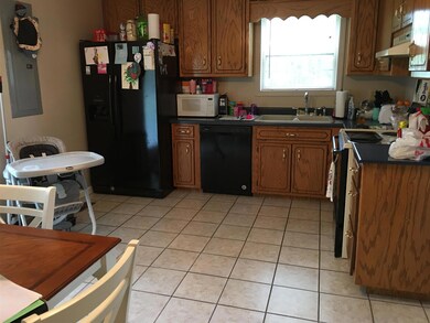 Light filled kitchen with pretty tile floor and access to the back patio and yard.