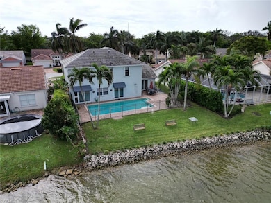 View of swimming pool with a water view, a patio, 
