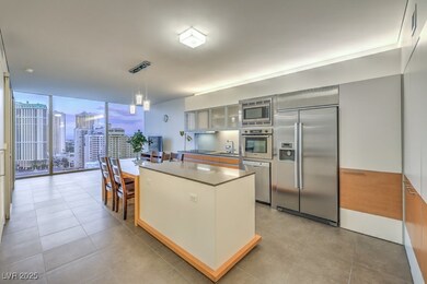 Kitchen with expansive windows, a kitchen island,