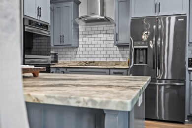 leathered granite countertops w/ tiled backsplash