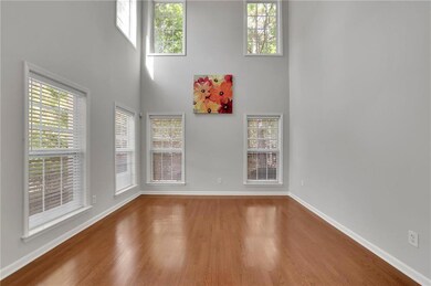 Unfurnished room with a high ceiling and wood finished floors